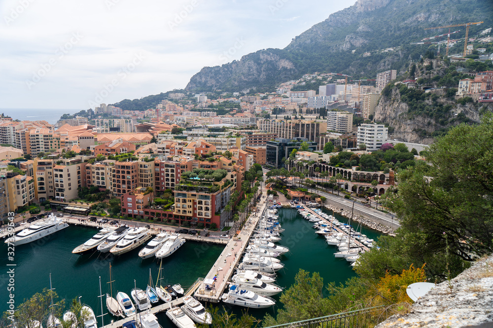 Naklejka premium Precious apartments and harbor with luxury yachts in the bay,Monte Carlo,Monaco,Europe