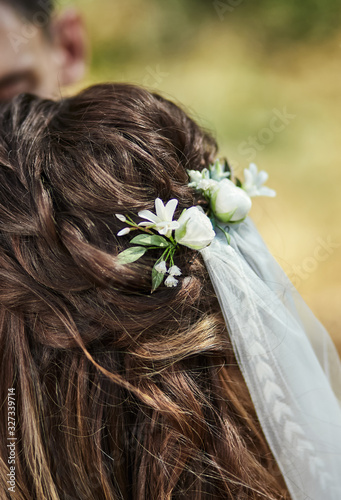 Beautiful bride hairstyle decorated with fresh flowers