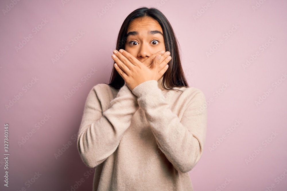 Young beautiful asian woman wearing casual turtleneck sweater over pink background shocked covering mouth with hands for mistake. Secret concept. Young beautiful asian woman wearing casual turtleneck sweater over pink background shocked covering mouth with hands for mistake. Secret concept.
