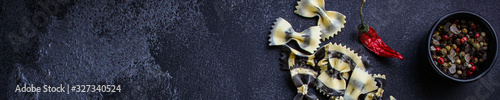 pasta farfalle cuttlefish ink (healthy eating, black multi-colored) menu concept. food background. top view. copy space