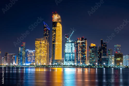 Night view of Abu Dhabi financial district skyline. Luxury lifestyle hotels and business. United Arab Emirates. 