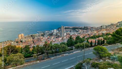 Cityscape timelapse of Monte Carlo, Monaco with roofs of buildings during summer sunset.