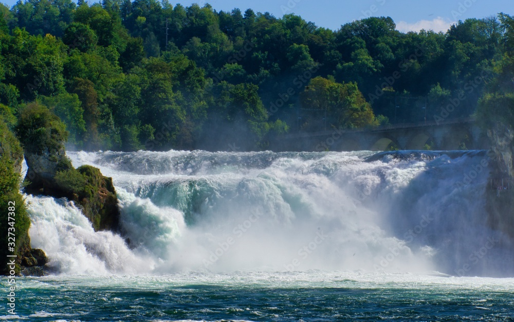 the famous rhine falls in the swiss near the city of Schaffhausen - sunny day and blue sky the famous rhine falls in the swiss near the city of Schaffhausen - sunny day and blue sky