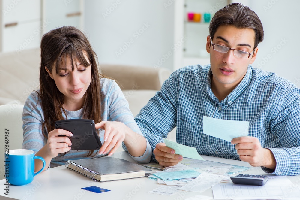 Young couple looking at family finance papers Young couple looking at family finance papers