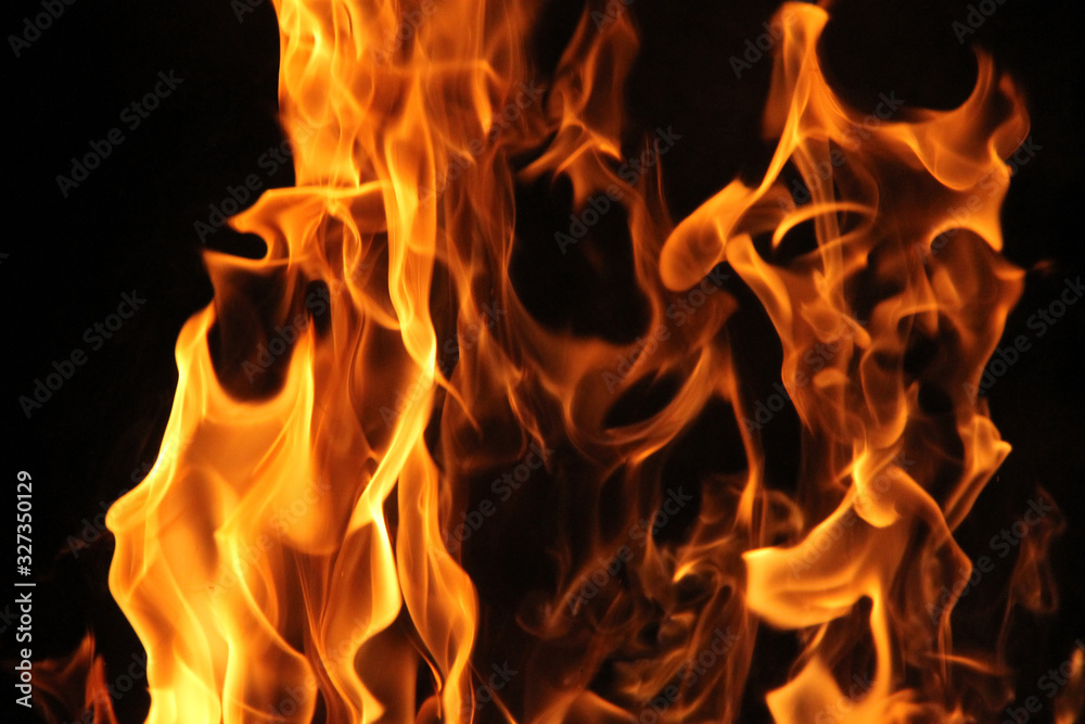 Blurred burning fire flame on the black background. Blurred burning fire flame on the black background.