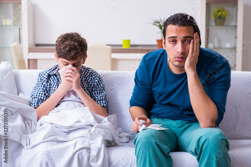 Young father caring for sick son