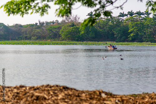A group of unrecognisable four people is boating on Karanji Lake, Mysore, India © Dan Tiégo