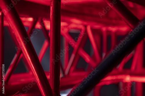 Glowing metal pipes, a DJ table with red lighting.