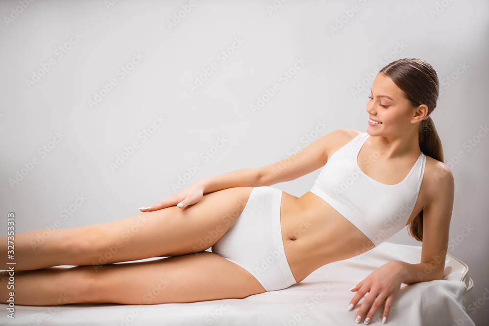 young and beautiful caucasian woman after hair removal procedure. laser epilation and cosmetology in beauty salon. attractive brunette woman has perfect smooth and soft skin on whole body young and beautiful caucasian woman after hair removal procedure. laser epilation and cosmetology in beauty salon. attractive brunette woman has perfect smooth and soft skin on whole body