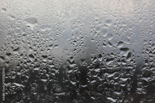 raindrops on the window on a blurred background of inclement weather