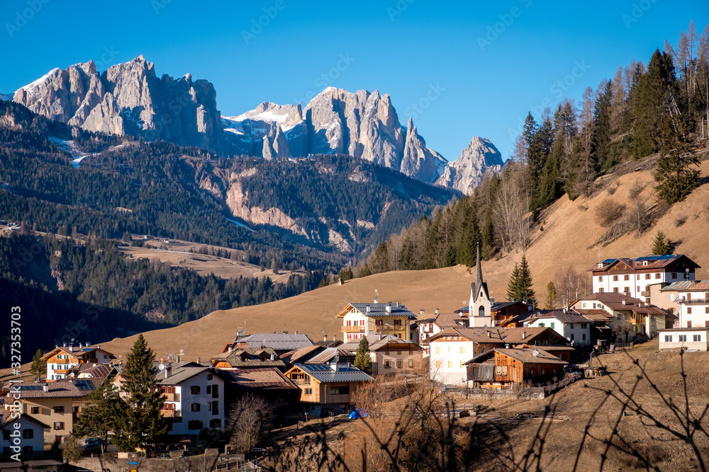 Beautiful autumn alpine landscape with church and alpine houses. Soraga. Moena. Bolzano province. South tyrol. Italy