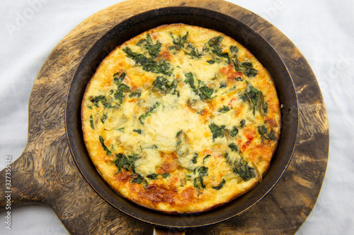 Frittata made of eggs, bacon, cheese and spinach