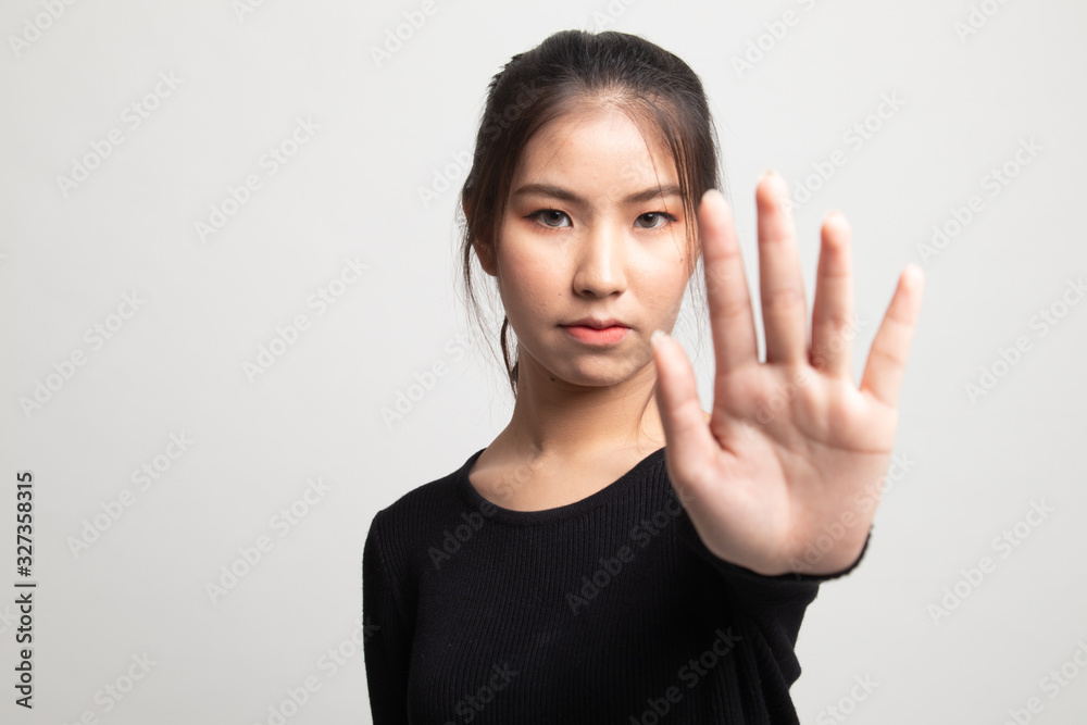 Portrait of an asian woman showing stop gesture. Portrait of an asian woman showing stop gesture.