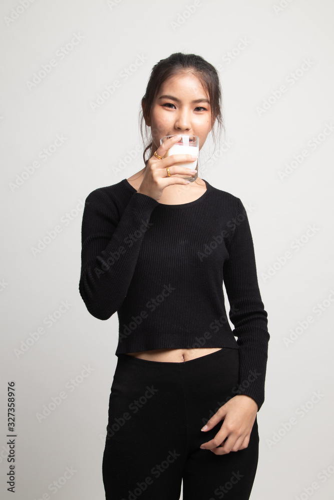 Healthy Asian woman drinking a glass of milk. Healthy Asian woman drinking a glass of milk.