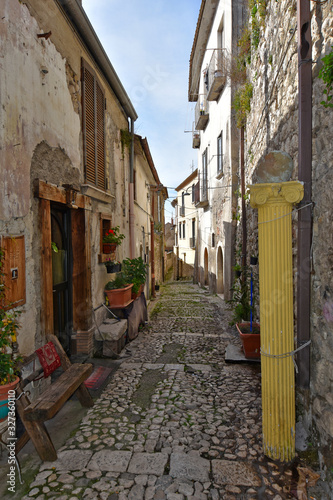 Fototapeta Naklejka Na Ścianę i Meble -  Montesarchio, Italy, 02/29/2020. A narrow street between the old houses of a medieval village.