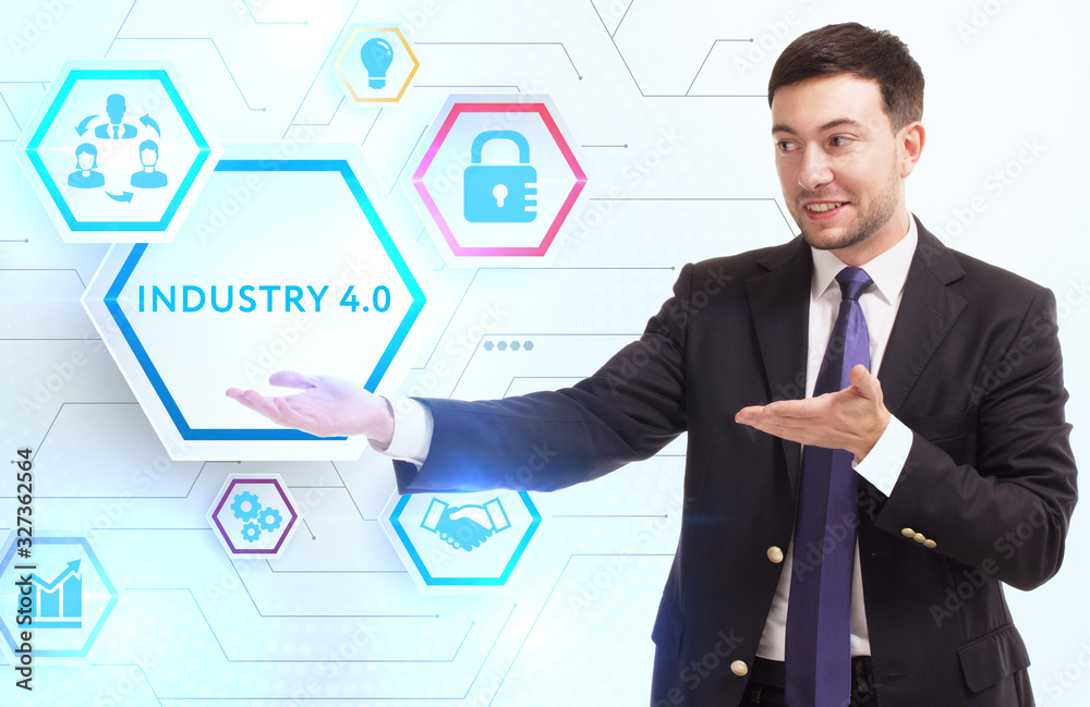 Business, Technology, Internet and network concept. Young businessman working on a virtual screen of the future and sees the inscription: Industry 4.0 Business, Technology, Internet and network concept. Young businessman working on a virtual screen of the future and sees the inscription: Industry 4.0