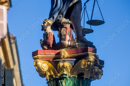 Justice fountain in the old town of Neuchatel, Switzerland photo