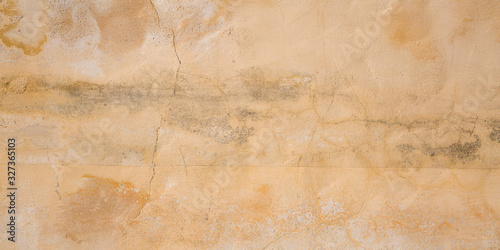 Texture of concrete wall cracks scratches beige background
