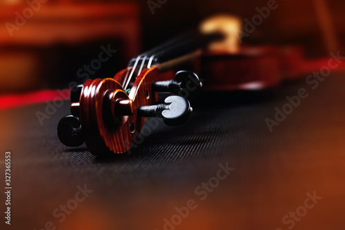Blurred Scroll of violin put on background,vintage and art tone,blurry light around