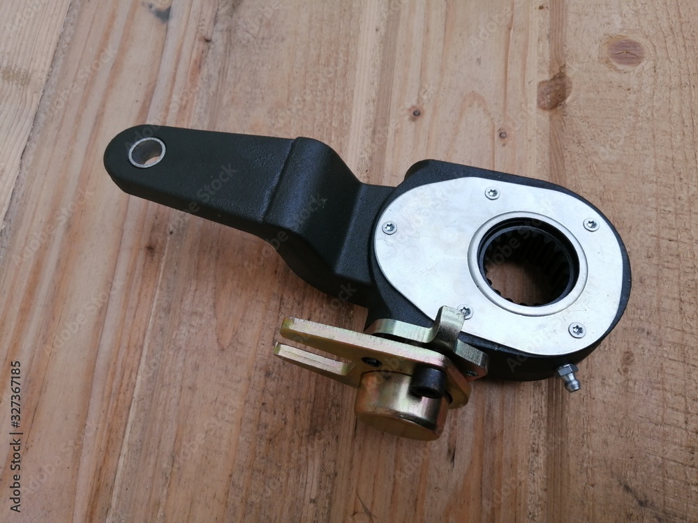 Obraz premium new bus spare part ratchet on wooden background