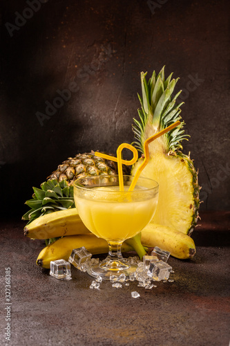 Delicious icy cocktail with fruits on dark grounge background. Healthy colorfull fruit shakes with ice on textured table. photo