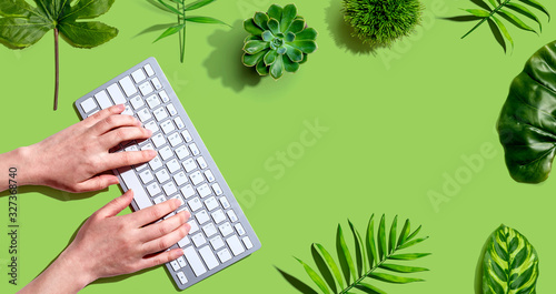 Woman using a computer keyboard - overhead view photo