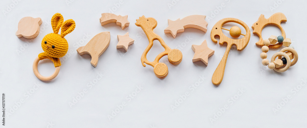 Wooden toys and teethers on white background