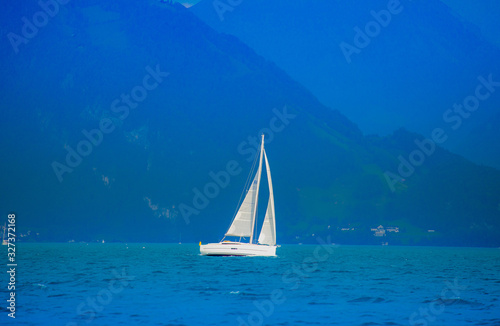 Sailboat in the lake Lucerne, Switzerland When the sky is bright, white clouds