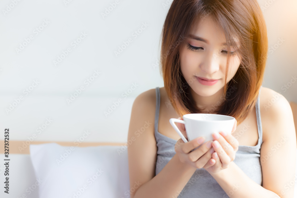 Young asian woman drinking delicious hot black coffee on bed in the morning at house. Attractive young Asia girl doesn’t eat sweet because she get diet. Beauty female holding cup of coffee. copy space Young asian woman drinking delicious hot black coffee on bed in the morning at house. Attractive young Asia girl doesn’t eat sweet because she get diet. Beauty female holding cup of coffee. copy space