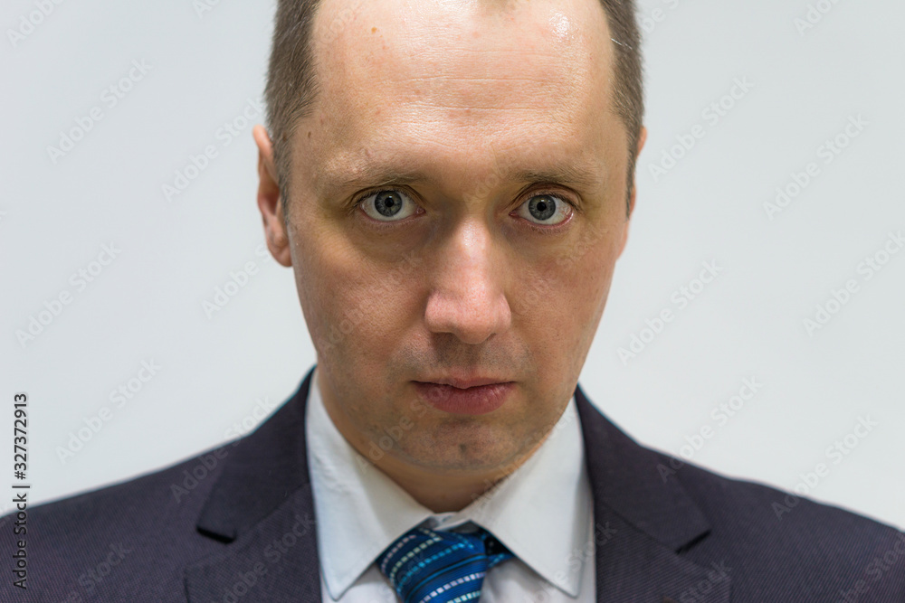 portrait of a confident, purposeful, successful businessman weared in grey suit and blue neck tie portrait of a confident, purposeful, successful businessman weared in grey suit and blue neck tie
