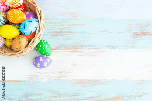 Canvas Print groups of colorful easter eggs in the basket on the blue wooden table preparing