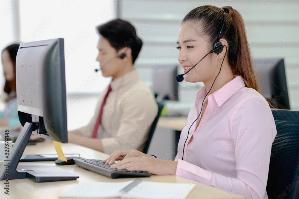 Call center worker accompanied by her team. Call center worker accompanied by her team.