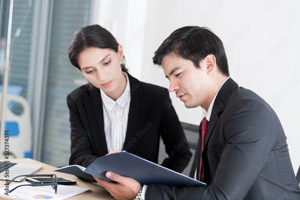 A manager and secretary working together in the office. A manager and secretary working together in the office.