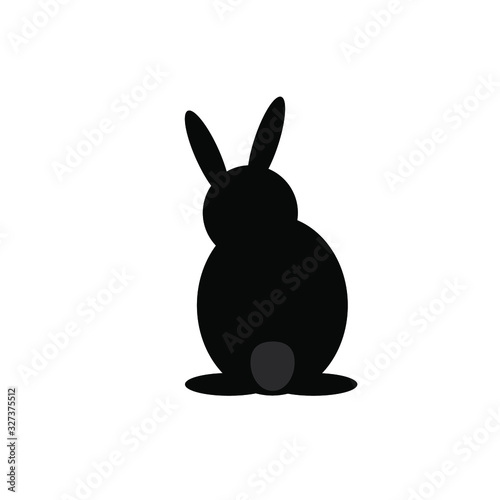 the black hare is sitting with his back turned