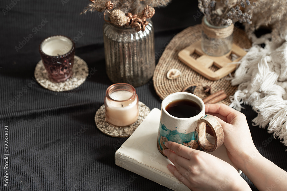 Still life with a beautiful Cup and female hands.