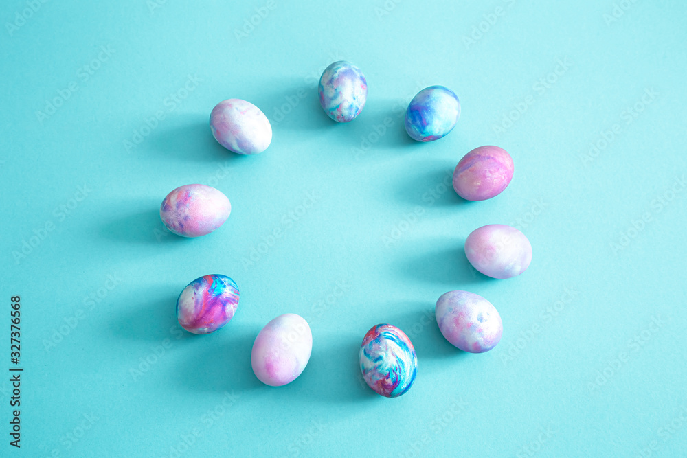 Circle of Easter eggs on a colored isolated background.