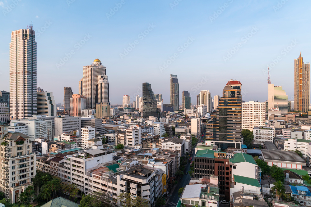 Fototapeta premium Aerial cityscape of picturesque Bangkok at daytime from rooftop. Panoramic skyline of the biggest city in Thailand. The concept of metropolis.