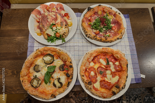 Four pizzas in a restaurant