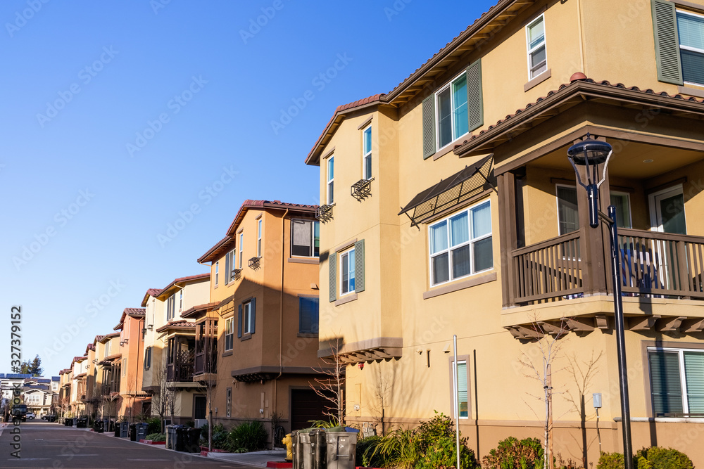 Exterior view of a row of identical townhouses; Sunnyvale, San Francisco bay area, California