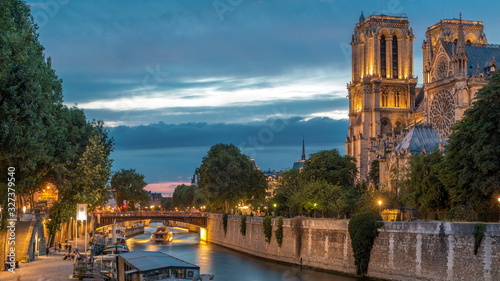 Cathedral Notre Dame de Paris day to night timelapse after sunset in Paris, France.