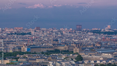 Aerial view of a large city skyline at sunset timelapse. Top view from the Eiffel tower. Paris, France.