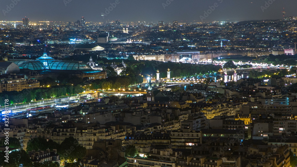 Aerial Night timelapse view of Paris City and Seine river shot on the top of Eiffel Tower