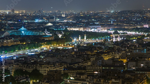 Aerial Night timelapse view of Paris City and Seine river shot on the top of Eiffel Tower © neiezhmakov