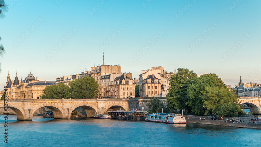 Sunset timelapse over Seine river, Pont Neuf bridge and Cite island with Royal palace, Conciergerie and medieval buildings. Paris, France