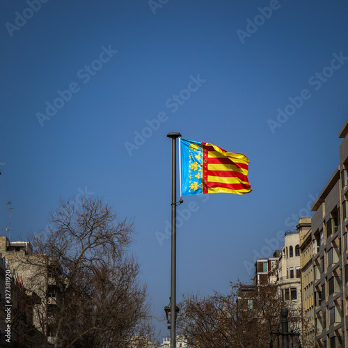 Flag of Valencia Spain on Blue Sky Valencia City, Spain photo