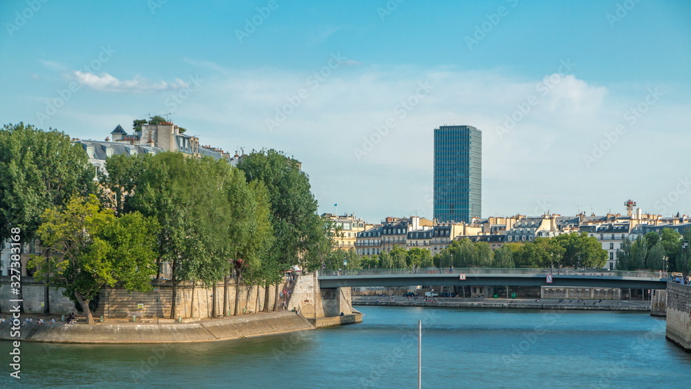 Embankment of the river Seine near Notre Dame with Saint-Louis bridge timelapse.
