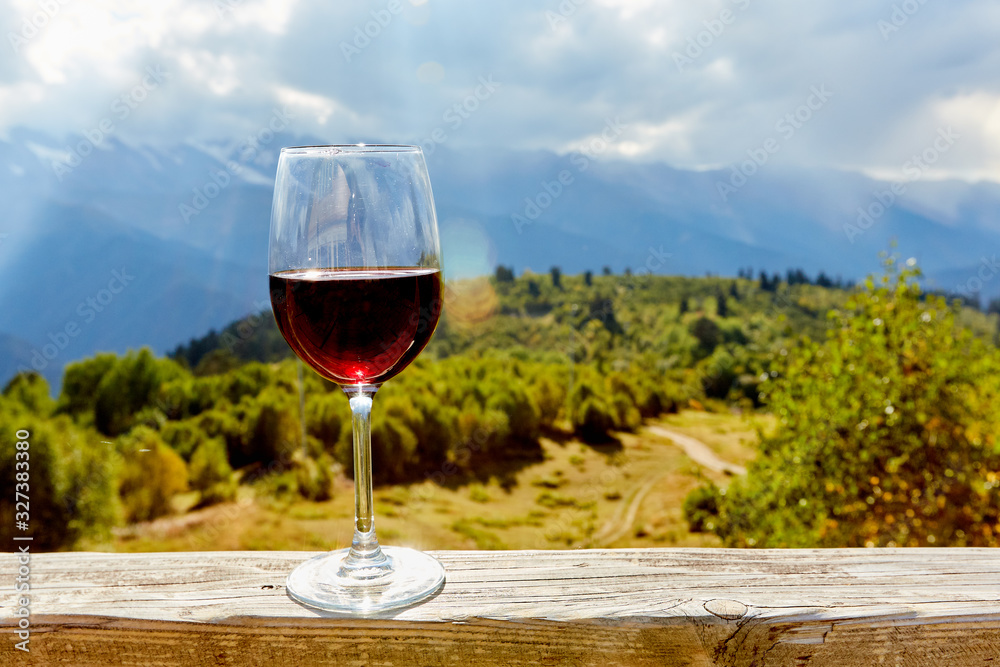 glass of wine in mountains - obrazy, fototapety, plakaty 