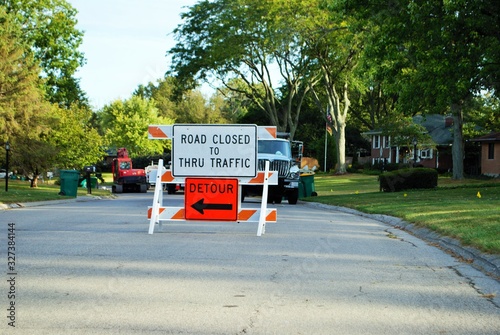 road closed to thru traffic detour construction sign in a residential neighborhood