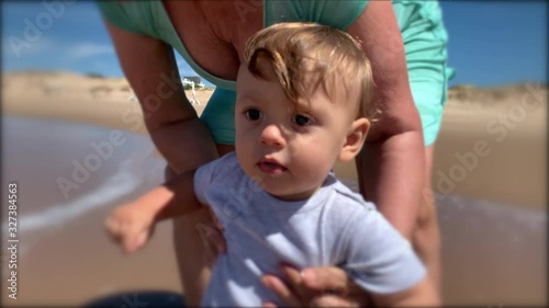 Toddler at beach shore for first time. Baby infant feeling water photo