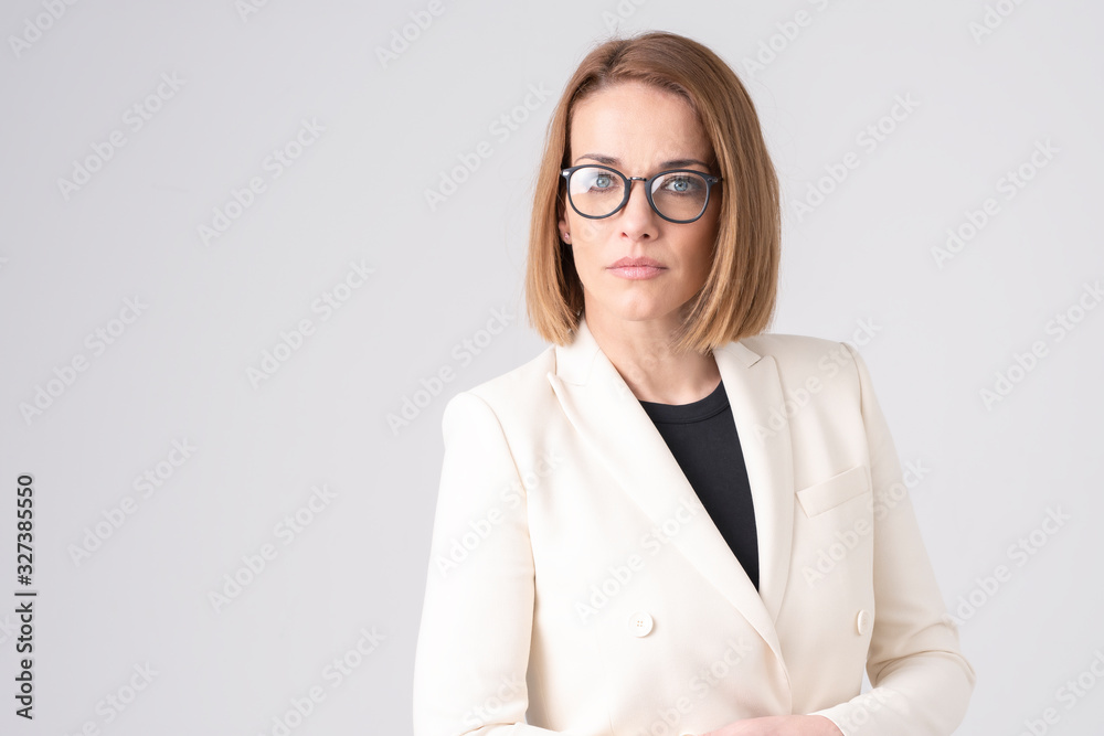 Confident mature businesswoman standing at isolated white background Confident mature businesswoman standing at isolated white background